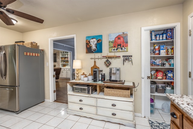 kitchen featuring stainless steel fridge, ceiling fan, and light tile patterned flooring