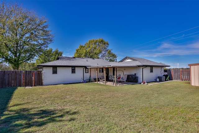 rear view of property with a patio area, a yard, and central AC