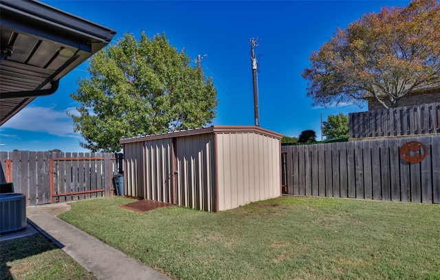 view of yard with a storage shed and central AC