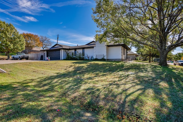 single story home with a garage and a front yard