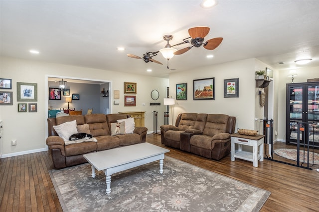 living room featuring hardwood / wood-style flooring and ceiling fan