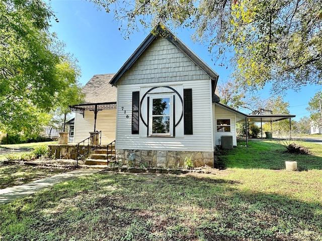 exterior space featuring a lawn and cooling unit