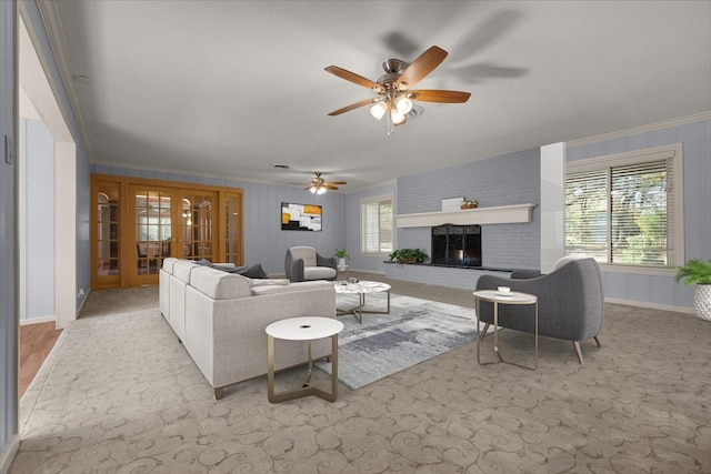 living room featuring ceiling fan, french doors, crown molding, and a brick fireplace