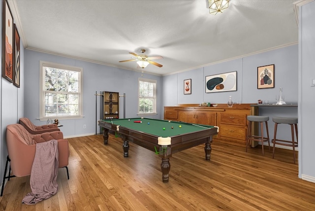 game room featuring plenty of natural light, crown molding, and light hardwood / wood-style flooring