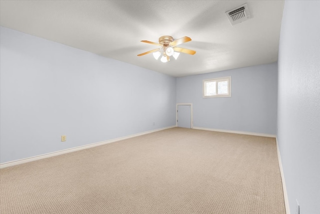 empty room featuring light colored carpet and ceiling fan