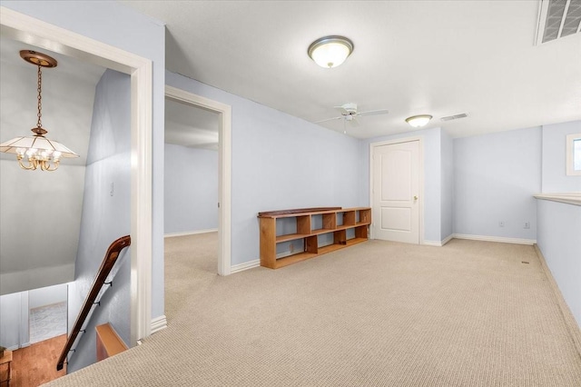 basement with ceiling fan and light carpet