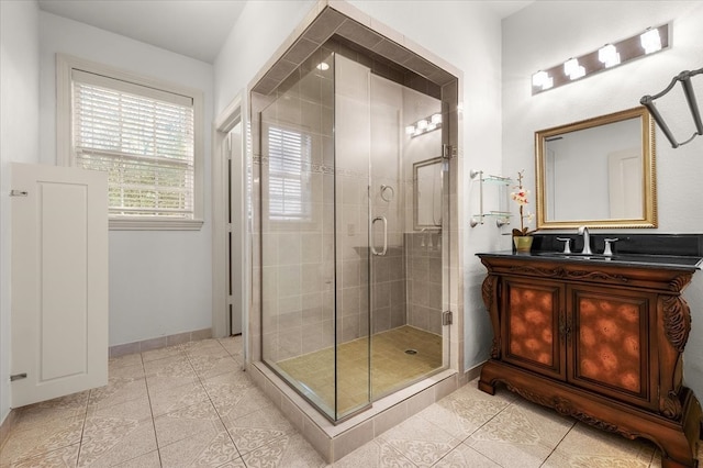 bathroom with tile patterned flooring, vanity, and an enclosed shower