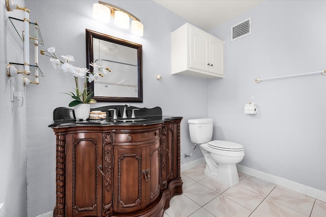 bathroom featuring toilet, vanity, and tile patterned floors