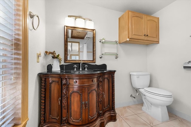 bathroom featuring tile patterned flooring, vanity, and toilet