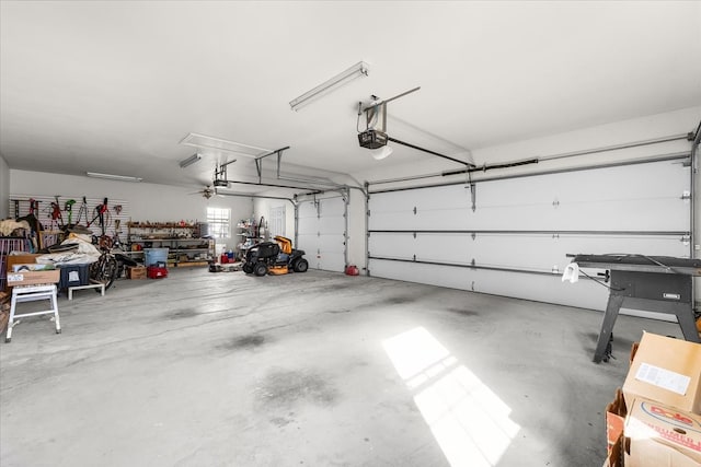 garage featuring ceiling fan and a garage door opener