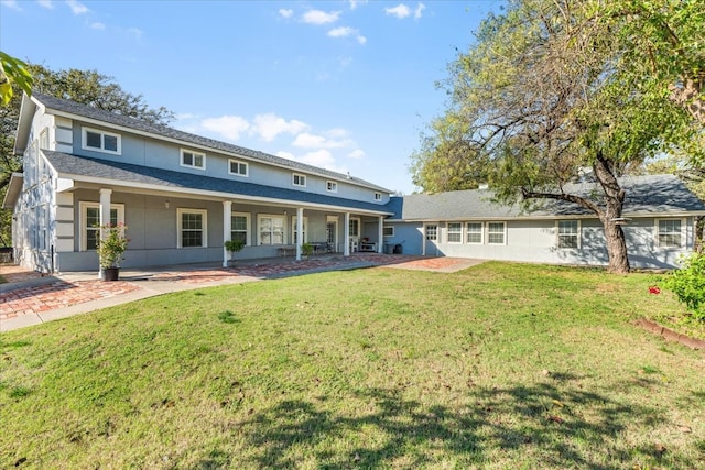 back of house featuring a lawn and a patio area