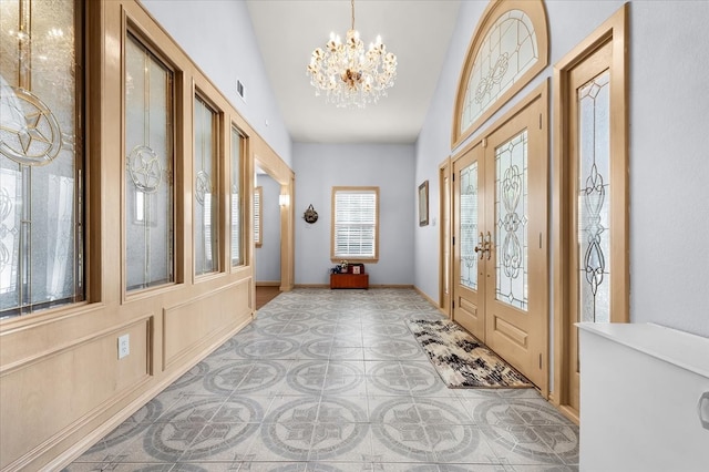 foyer entrance featuring lofted ceiling and an inviting chandelier