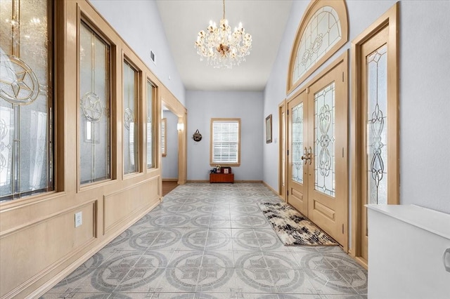 entryway featuring a notable chandelier and french doors