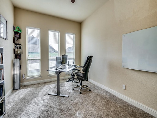 office area featuring carpet floors, baseboards, and a ceiling fan