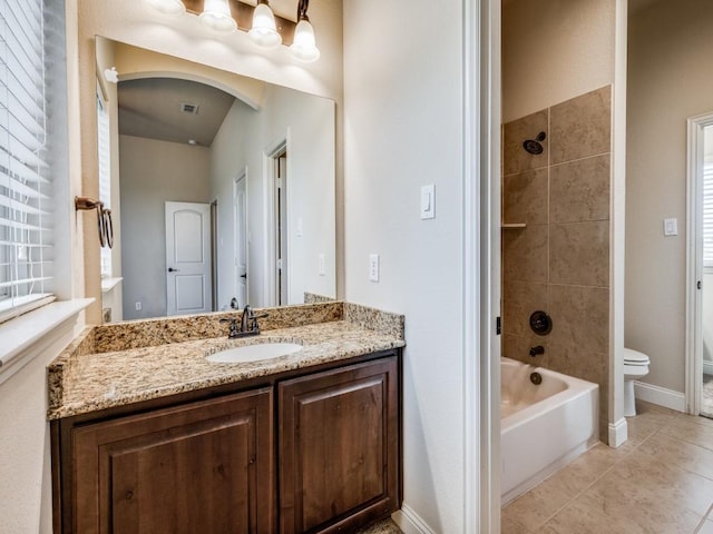 full bathroom featuring toilet, bathing tub / shower combination, baseboards, vanity, and tile patterned floors