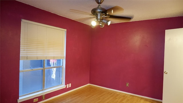 unfurnished room featuring ceiling fan and wood-type flooring