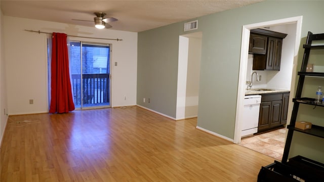 unfurnished living room with light hardwood / wood-style floors, ceiling fan, and sink