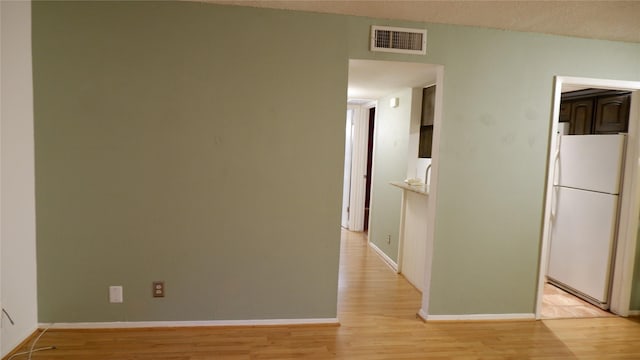 hall with light hardwood / wood-style flooring