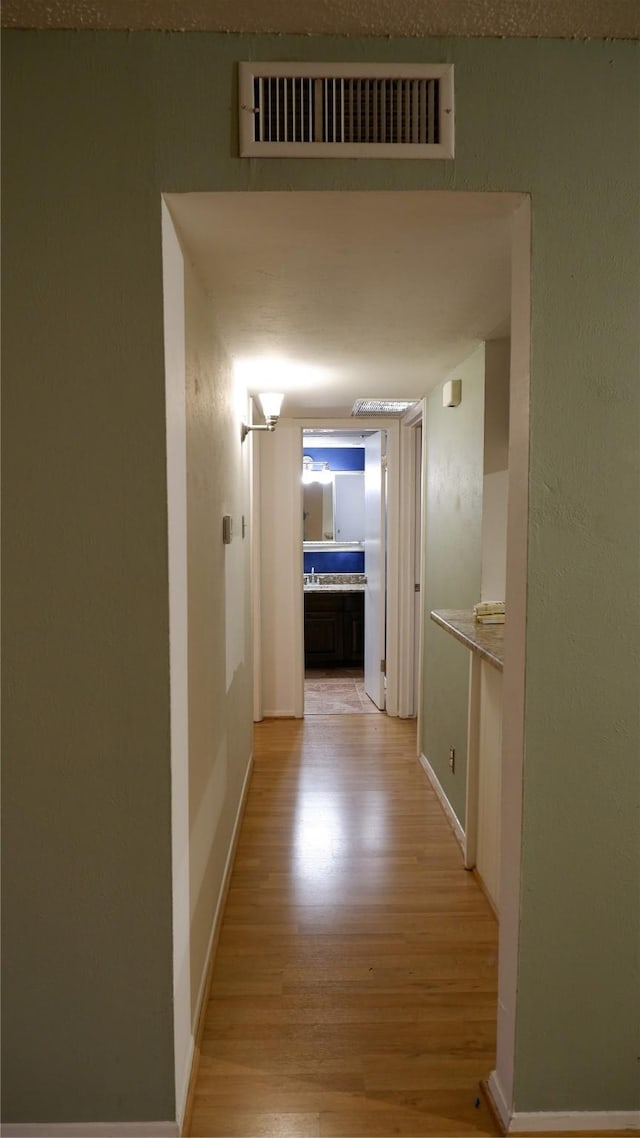 hallway with light wood-type flooring