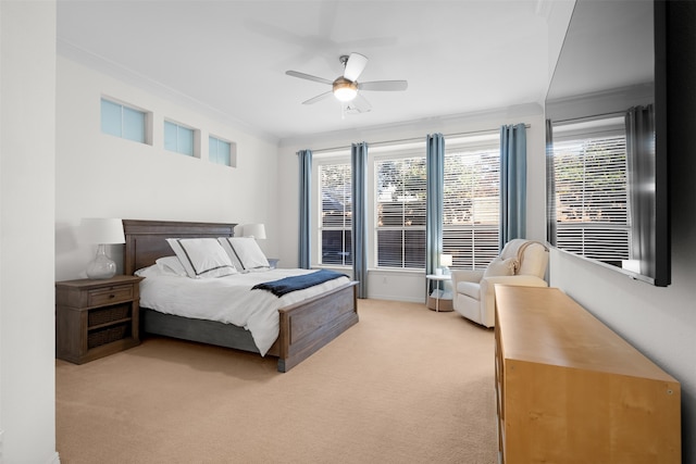 bedroom with ornamental molding, ceiling fan, and light colored carpet