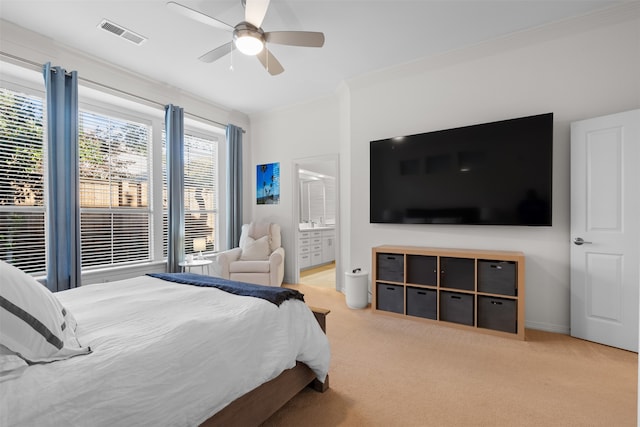 carpeted bedroom with ceiling fan, crown molding, and ensuite bath