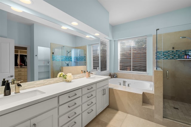 bathroom featuring vanity, tile patterned floors, and shower with separate bathtub