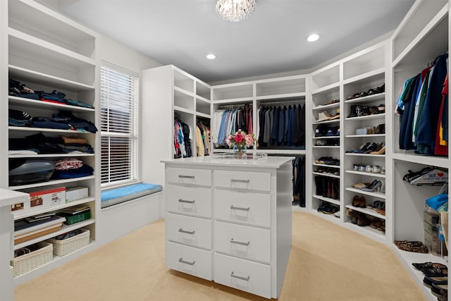 walk in closet featuring light colored carpet