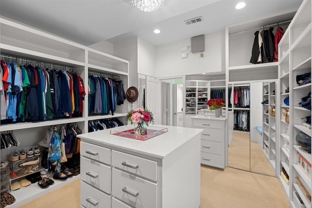 spacious closet featuring light carpet