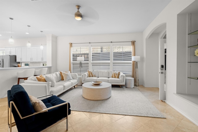 living room with ceiling fan and light tile patterned floors