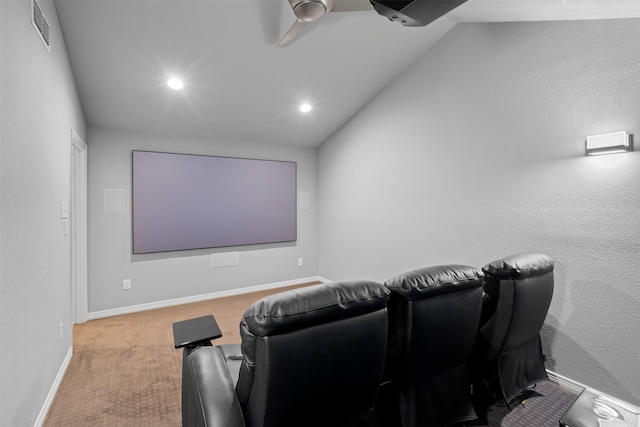 home theater featuring ceiling fan, light colored carpet, and lofted ceiling