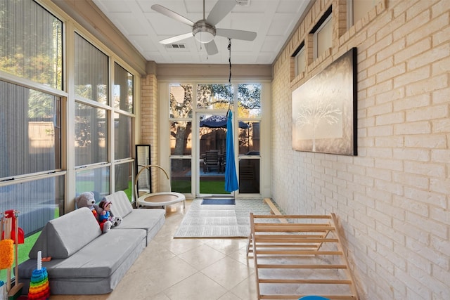 sunroom / solarium featuring ceiling fan