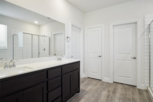 bathroom with vanity and an enclosed shower