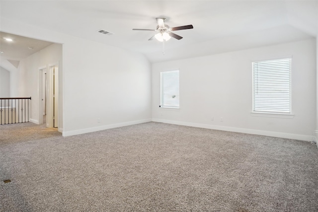 carpeted empty room featuring ceiling fan and lofted ceiling