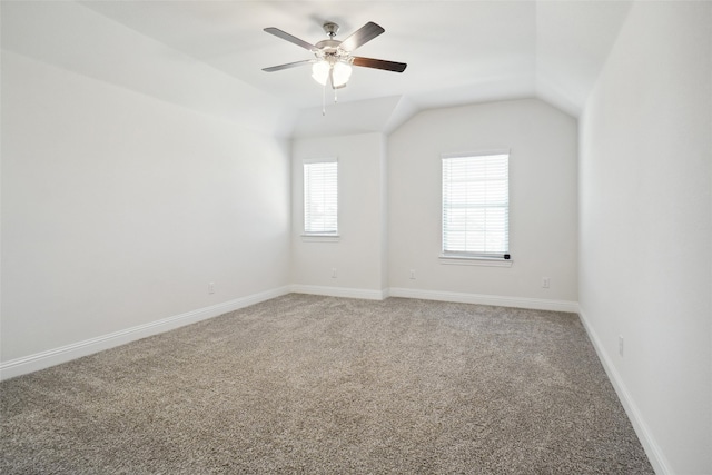 unfurnished room with ceiling fan, lofted ceiling, and carpet flooring