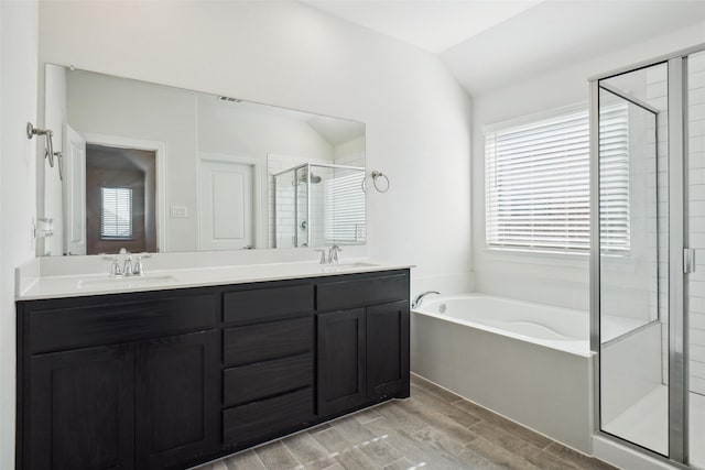 bathroom featuring lofted ceiling, vanity, and independent shower and bath