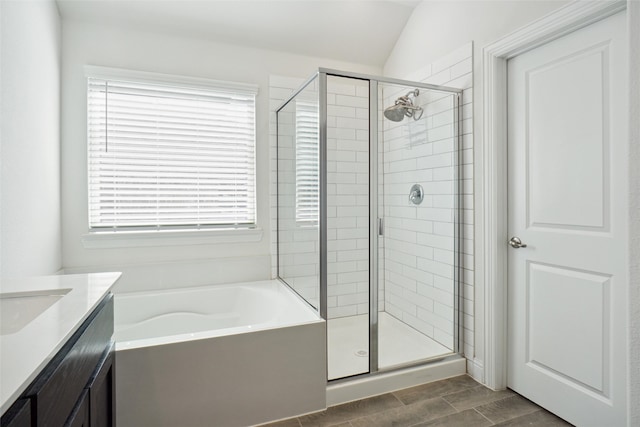 bathroom featuring lofted ceiling, vanity, and independent shower and bath