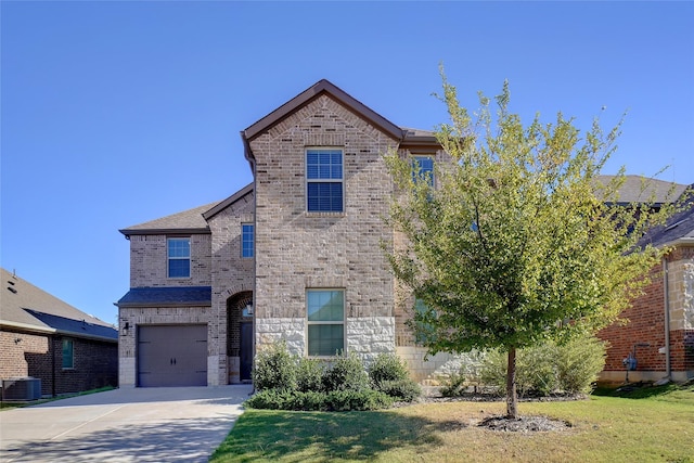 front of property featuring a garage, a front lawn, and central air condition unit