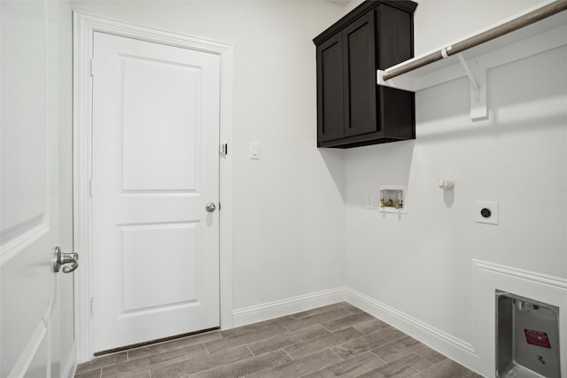 laundry area featuring gas dryer hookup, cabinets, hookup for a washing machine, and hookup for an electric dryer