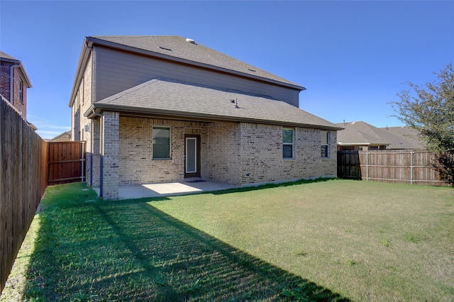 rear view of property featuring a yard and a patio