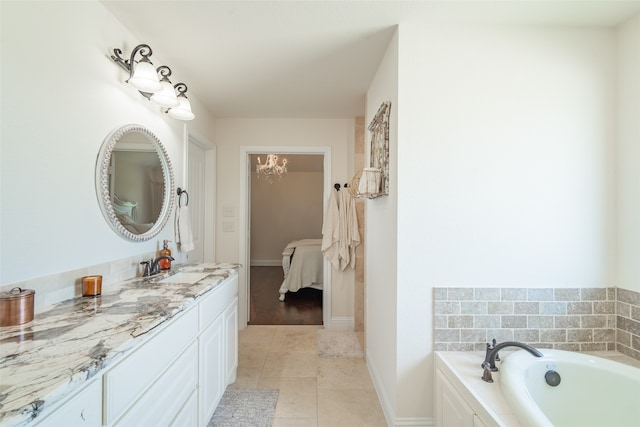 bathroom featuring tile patterned floors, vanity, and a washtub