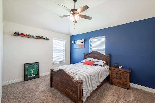 carpeted bedroom featuring multiple windows, lofted ceiling, and ceiling fan