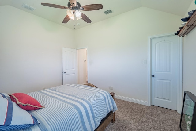 bedroom with ceiling fan, lofted ceiling, and carpet flooring