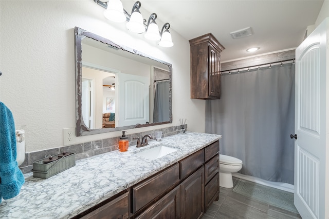 bathroom featuring vanity, curtained shower, and toilet