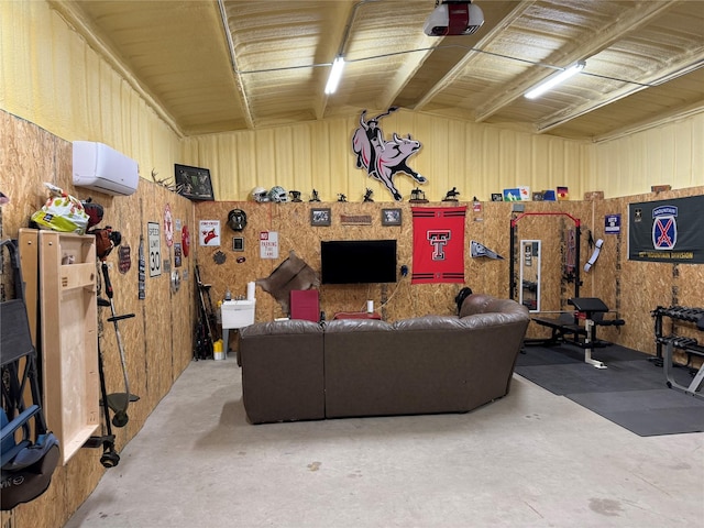 living room featuring concrete flooring and a wall unit AC