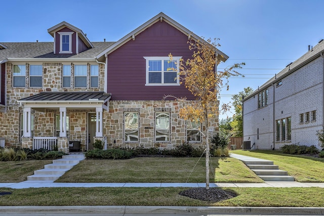 view of front of property with a front yard, a porch, and cooling unit