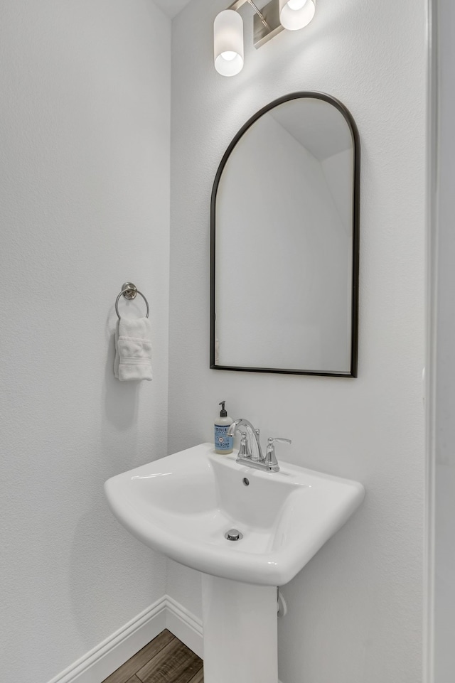 bathroom with wood-type flooring and sink