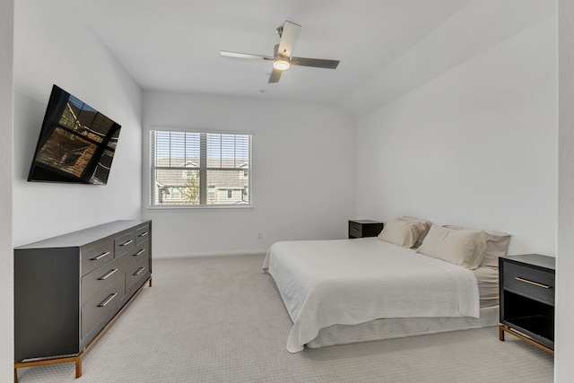 bedroom featuring ceiling fan, light colored carpet, and lofted ceiling