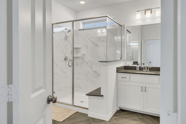 bathroom featuring vanity and a shower with shower door