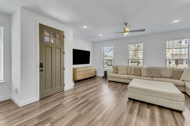 living room featuring ceiling fan and hardwood / wood-style flooring