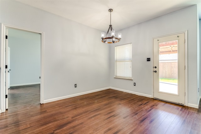 interior space with dark wood-type flooring and a notable chandelier